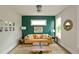 Cozy living room with stylish green accent wall, complemented by neutral furniture and ample natural light at 533 Beecham Dr, Smyrna, GA 30082