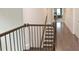 Elegant staircase with dark wooden railings and hardwood floors, leading to the upper level of the home at 533 Beecham Dr, Smyrna, GA 30082