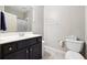Bathroom with a white toilet, grey wall paint, a sink with storage beneath, and white trim at 825 Kennedy Ct, Loganville, GA 30052
