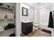 Updated bathroom features a shower and tub combination and dark wood-look floors at 825 Kennedy Ct, Loganville, GA 30052