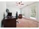 Spacious room with computer setup, chair, windows allowing lots of natural light, carpet, and ceiling fan at 825 Kennedy Ct, Loganville, GA 30052