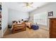 Bedroom with two twin beds, ceiling fan, carpeted floors, and natural light from the window at 825 Kennedy Ct, Loganville, GA 30052
