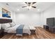 Cozy bedroom with wood floors, ceiling fan, and modern decor, perfect for relaxing at 825 Kennedy Ct, Loganville, GA 30052