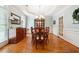 Formal dining room with elegant furnishings, a chandelier, wainscoting, and ample natural light at 825 Kennedy Ct, Loganville, GA 30052