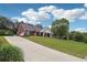 An exterior view showing the home's facade, driveway, and landscaped front yard on a sunny day at 825 Kennedy Ct, Loganville, GA 30052