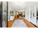 Inviting foyer with hardwood floors, elegant rug, chandelier, and a glimpse into the living room at 825 Kennedy Ct, Loganville, GA 30052