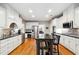 Modern kitchen featuring stainless steel appliances, granite countertops, and a stylish central island with seating at 825 Kennedy Ct, Loganville, GA 30052