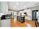 Well-lit kitchen featuring stainless steel appliances, a granite island with seating, and modern cabinetry at 825 Kennedy Ct, Loganville, GA 30052