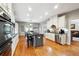 Bright, open kitchen with a central island, granite countertops, stainless steel appliances, and hardwood floors at 825 Kennedy Ct, Loganville, GA 30052