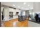 Spacious kitchen featuring stainless steel appliances, granite countertops, white cabinetry, and a central island at 825 Kennedy Ct, Loganville, GA 30052