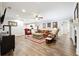 Spacious living room features a ceiling fan, recessed lighting and hardwood floors at 825 Kennedy Ct, Loganville, GA 30052
