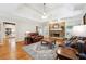 Open-concept living room featuring hardwood floors, a fireplace, comfortable seating, and an airy feel at 825 Kennedy Ct, Loganville, GA 30052
