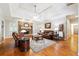 Inviting living room features hardwood floors, stone fireplace, comfortable seating, and an area rug at 825 Kennedy Ct, Loganville, GA 30052