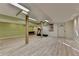 Spacious basement featuring laminate floors, wooden columns, and a walkout door at 1450 Holly Bank Cir, Atlanta, GA 30338