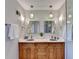 Bathroom with double vanity, decorative hanging lights, and framed mirrors at 1450 Holly Bank Cir, Atlanta, GA 30338