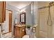Bathroom with granite countertops, custom mirror, wood cabinetry and glass enclosed shower at 1450 Holly Bank Cir, Atlanta, GA 30338