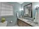 Powder blue bathroom with granite counters, a window, and decorative mirror and light fixture at 1450 Holly Bank Cir, Atlanta, GA 30338