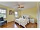 Bright bedroom with hardwood floors, windows with lake view, and a ceiling fan at 1450 Holly Bank Cir, Atlanta, GA 30338