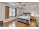 Cozy bedroom featuring a ceiling fan, natural light from the window, and hardwood floors at 1450 Holly Bank Cir, Atlanta, GA 30338