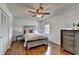 Cozy bedroom with a ceiling fan, hardwood floors, and a decorative gray bedframe at 1450 Holly Bank Cir, Atlanta, GA 30338