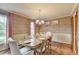 Charming dining room featuring hardwood floors, elegant lighting, and classic wallpaper at 1450 Holly Bank Cir, Atlanta, GA 30338