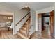 Inviting foyer with hardwood floors, a staircase, and views into the dining room at 1450 Holly Bank Cir, Atlanta, GA 30338