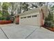 Exterior of garage with white door, brick siding, and concrete driveway at 1450 Holly Bank Cir, Atlanta, GA 30338