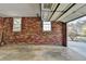 Spacious garage with brick walls and two windows at 1450 Holly Bank Cir, Atlanta, GA 30338