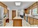 Eat-in kitchen featuring custom cabinets, an island and stainless steel appliances at 1450 Holly Bank Cir, Atlanta, GA 30338