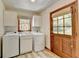 Functional laundry room with washer, dryer, and direct exterior access at 1450 Holly Bank Cir, Atlanta, GA 30338