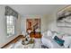 Bright living room featuring a white couch and decorative window treatment at 1450 Holly Bank Cir, Atlanta, GA 30338