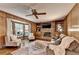 Cozy living room featuring wood paneling, a brick fireplace, and built-in shelving at 1450 Holly Bank Cir, Atlanta, GA 30338