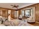 Spacious living room with wood paneling, large windows, and comfortable seating arrangement at 1450 Holly Bank Cir, Atlanta, GA 30338