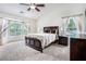 Relaxing main bedroom featuring a large window and cozy dark wood accents at 1625 Summit View Way, Snellville, GA 30078