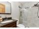 Bathroom featuring a vanity sink and a tiled shower with a glass enclosure at 1981 Luke Edwards Rd, Dacula, GA 30019