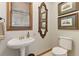 Bathroom with pedestal sink, framed art, and tile flooring at 1981 Luke Edwards Rd, Dacula, GA 30019