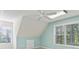 Light blue bedroom with vaulted ceilings and large windows offers bright, natural light at 1981 Luke Edwards Rd, Dacula, GA 30019