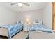 Bedroom features two twin beds, neutral carpet, a window, and a ceiling fan at 1981 Luke Edwards Rd, Dacula, GA 30019
