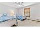 Bedroom featuring two twin beds, neutral carpet, a window, and a ceiling fan at 1981 Luke Edwards Rd, Dacula, GA 30019