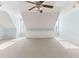 Large bonus room with a vaulted ceiling and built-in shelves, illuminated by natural light at 1981 Luke Edwards Rd, Dacula, GA 30019