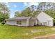 Exterior home view showcases white siding, green lawn, and well-maintained landscaping at 1981 Luke Edwards Rd, Dacula, GA 30019