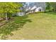A charming white home with a welcoming porch on a large lot with mature trees at 1981 Luke Edwards Rd, Dacula, GA 30019