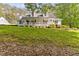 Charming white home with a welcoming porch, surrounded by lush greenery and a well-manicured lawn at 1981 Luke Edwards Rd, Dacula, GA 30019