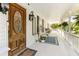 Inviting front porch with a decorative door, hanging plants, and ample seating at 1981 Luke Edwards Rd, Dacula, GA 30019