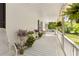 Spacious front porch with white railings, lush plants, and comfortable seating area at 1981 Luke Edwards Rd, Dacula, GA 30019