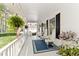 Relaxing front porch with outdoor seating, hanging plants, and an American flag at 1981 Luke Edwards Rd, Dacula, GA 30019