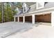Three-car garage with a long driveway provides parking and extra storage space at 1981 Luke Edwards Rd, Dacula, GA 30019