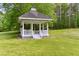 Charming gazebo with detailed railings on manicured lawn, ideal for outdoor relaxation and enjoying the surroundings at 1981 Luke Edwards Rd, Dacula, GA 30019
