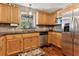 Bright kitchen with granite countertops, stainless appliances, and wood cabinetry at 1981 Luke Edwards Rd, Dacula, GA 30019