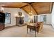 Warm living room featuring a wood-burning stove, exposed ceiling beams, and natural light at 1981 Luke Edwards Rd, Dacula, GA 30019